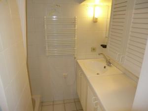 a white bathroom with a sink and a shower at Holiday Home Le Mazet by Interhome in Les Lecques