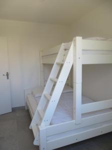 a white bunk bed with a ladder on it at Résidence "Les cyclistes", appartement "Akotee" in Malaucène