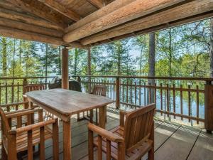 a wooden porch with a table and chairs on a deck at Holiday Home Patu by Interhome in Pihlajaniemi +13 photos