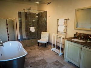 a bathroom with a tub and a shower and a sink at Hotel Villa Casanova in Lucca