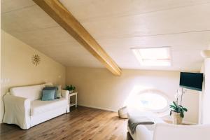 a living room with a white couch and a window at Nontiscordardimé B&B Villa Agriturismo in Civitanova Marche