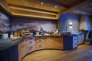 a kitchen with a large wooden island in a room at Hotel Garni Zugspitz in Farchant