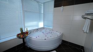 a bath tub in a bathroom with a window at Cleopatra Golden Beach Hotel in Alanya +42 photos
