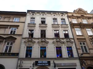 a tall white building with many windows at Greg&Tom Beer House Hostel in Krakow