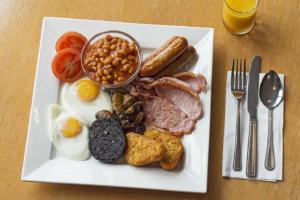 a plate of breakfast food with eggs bacon beans and toast at The Savoy Hotel in Blackpool