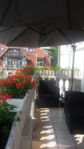 a patio with some plants and an umbrella at Sopot: apartament closest to the sea in Sopot