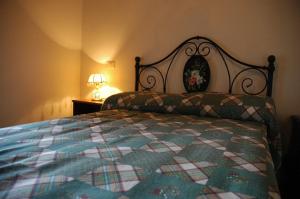 a bedroom with a bed with a quilt on it at Casa Mimmo in Castiglione in Teverina