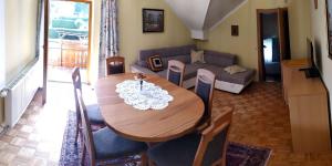a living room with a table and a couch at Ferienwohnungen Schneider in Sankt Kanzian