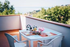 a table with a tea set on a balcony at La Torretta in Lerici