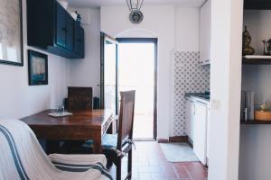 a kitchen with a wooden table and a dining room at La Torretta in Lerici