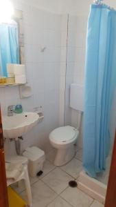 a bathroom with a toilet and a sink at Aeolos Hotel Apartments in Gythio