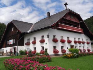 a large white building with flowers in front of it at Waschlgut in Ebenau