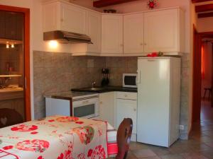 a kitchen with a white refrigerator and a table at Gite Dans Cité Médievale in Boersch