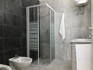 a bathroom with a shower and a toilet and a sink at DoppioBi in Torre Lapillo +17 photos