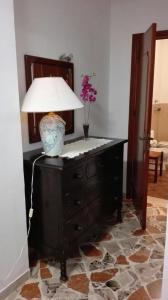 a lamp on top of a dresser with a lamp on it at A casa di Gio’ in Marsala