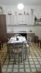 a kitchen with a table and chairs in a room at A casa di Gio’ in Marsala
