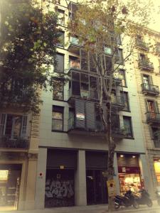 an apartment building with a motorcycle parked in front of it at Don Moustache Boutique Hostel in Barcelona