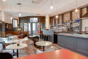 a restaurant with tables and chairs and a bar at Ibis Angers Centre Château in Angers