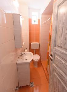 a bathroom with a white sink and a toilet at Vithos in Agnontas