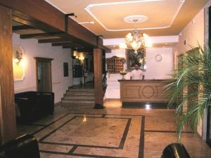 a lobby of a building with a man standing in the lobby at Hotel Lenzenhof in Oberau