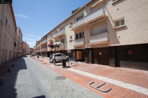 an empty street with a car parked next to buildings at T2 PRESTIGE BANDOL in Bandol