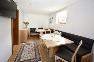 a dining room with a table and a couch at Haus Nannaree in Sankt Gallenkirch