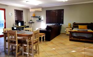a living room with a table and a couch at LE -DANTE in Klerksdorp
