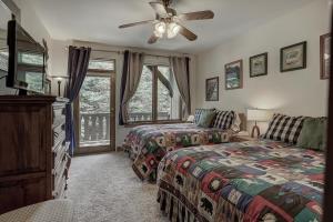 a bedroom with two beds and a ceiling fan at 2Br- Arrowhead Village- Great Location And Gorgeous Condo Condo in Beaver Creek +18 photos