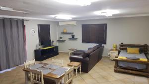 a living room with a couch and a table at LE -DANTE in Klerksdorp