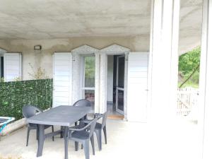 einen Tisch und Stühle auf der Veranda eines Hauses in der Unterkunft Viva La Vida 1 in Gandosso