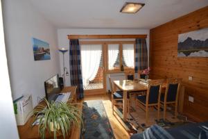 a living room with a dining room table and chairs at Haus Marent in Bartholomäberg