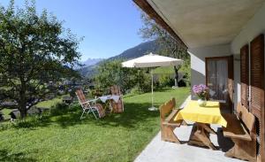 eine Terrasse mit einem Tisch und einem Sonnenschirm in der Unterkunft Haus Saler in Silbertal