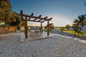 a wooden gazebo with a table and chairs at Hemdat Nefesh Eitan in Eitan