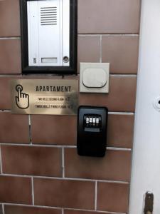a wall with a pay phone and a pay meter at Apartament Maryla in Giżycko
