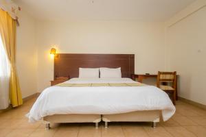 Säng eller sängar i ett rum på Corat Africa Hotel