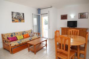 a living room with a couch and a table at UHC Bellavista Apartments in Salou