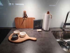 a kitchen counter with a tray and cups and a roll of paper towels at Le Bijou Bahnhofstrasse / Paradeplatz in Zürich