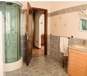 a bathroom with a shower and a sink at Villa Aurora in Olbia