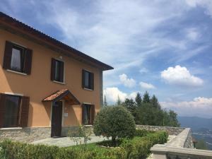 a house with a view of the mountains at Residence La Canonica in Costa Valle Imagna