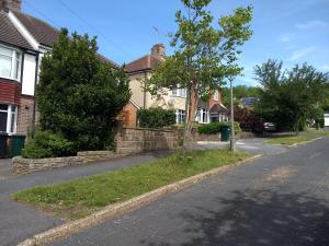 an empty street in a residential neighborhood with houses at Quiet comfortable Patcham studio Free parking Hallway shared with host in Brighton & Hove