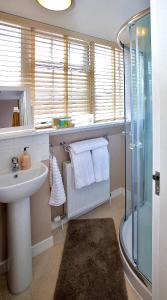 a bathroom with a sink and a shower at Paton Cottage in Inverness