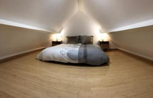 a bedroom with a bed in an attic at Gite en Normandie in Montabot