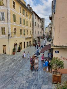 a group of people walking down a street at Appartement indépendant in Bastia