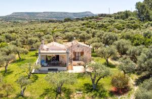 an aerial view of a house in a field with trees at Brassol Casa Vacanze Vista Mare in Alghero