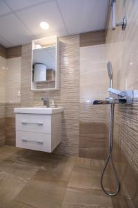 a bathroom with a sink and a mirror at Sunpark Studios in Sandanski