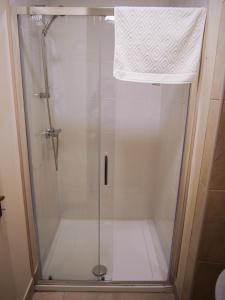 
a shower stall with a toilet and a shower curtain at Pure Magic Lodge in Slievemore
