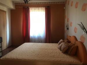 a bedroom with a large bed with a window at Nyaralo Balatonszárszó in Balatonszárszó