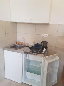 a small kitchen with a sink and a stove at Studio Apartment Sanja 3 in Neum +11 photos