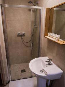 
a bathroom with a shower and a sink at Pure Magic Lodge in Slievemore
