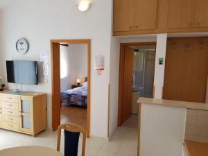 a room with a kitchen and a bedroom with a bed at Apartman Vida in Pula